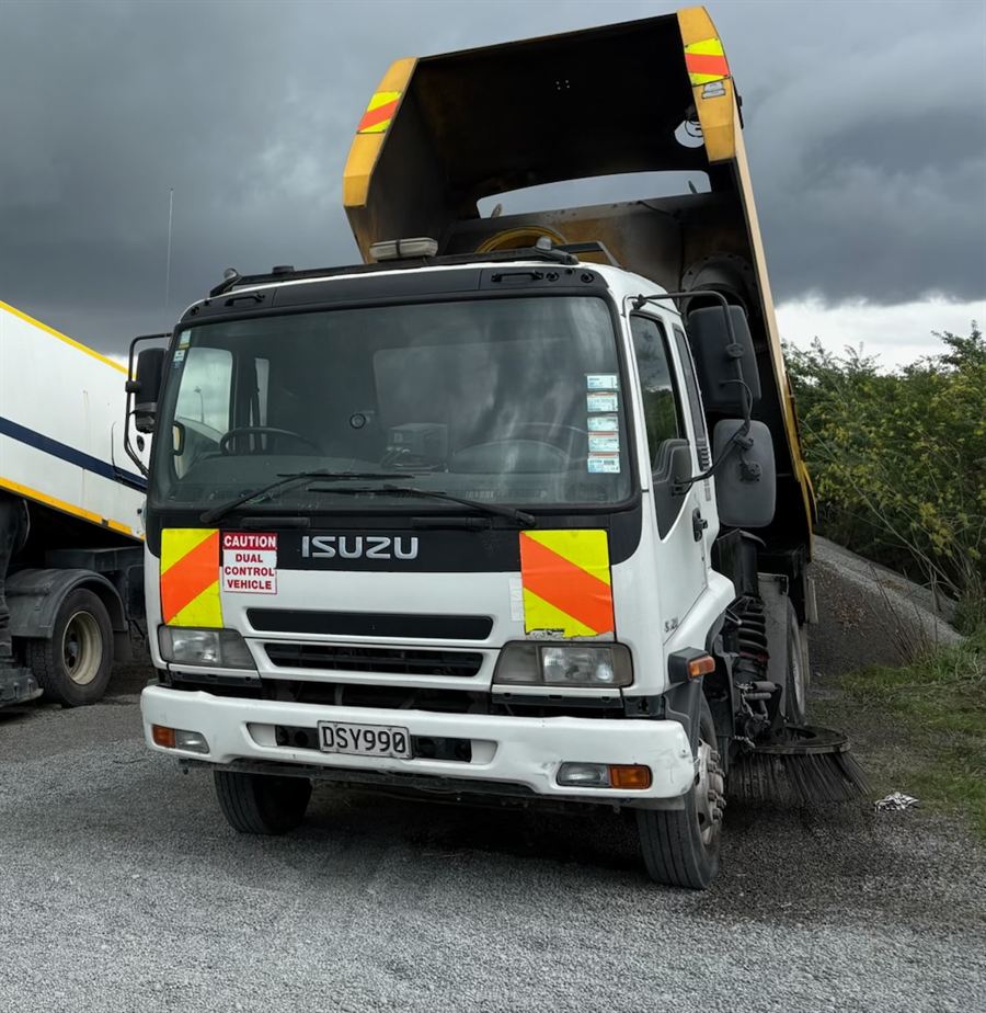 Isuzu tipper truck with sweeper unit, tipping body raised
